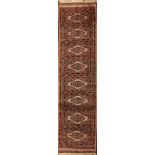 A Pakistan rug, Hatchli resign with an ivory panelled field and lozenge geometric border,