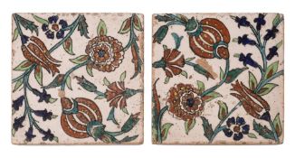 A pair of tiles decorated in the Iznik manner with tulips and other blooms amongst scrolling