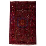 A Hamadan rug, the wine field with a blue octagonal stellar medallion,