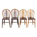 A composed set of four ash, elm and beech wheelback chairs,