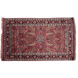 A Kashmir silk rug, the rose field with a design of palmettes and flowering stems,