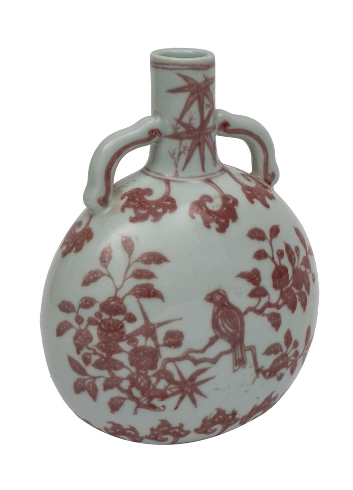 A Chinese porcelain moon flask painted front and verso in copper-red with a song bird amongst