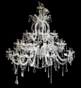 A contemporary cut glass three tier graduated twelve branch chandelier,