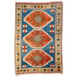 A Melas rug, the pastel blue field with triple brick red hooked octagonal medallions,