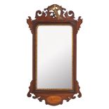 An Edwardian mahogany and partly gilt fret carved wall mirror in the George III taste,