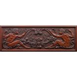 A carved mahogany figural relief panel in Arts and Crafts style,