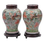 A pair of Chinese wucai 'Phoenix' jars of baluster form,