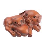 A Japanese boxwood netsuke in the form of a sow and piglet,
