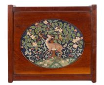 An oval petit point embroidery depiction of a deer in a landscape, in Arts and Crafts style,
