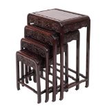 An early 20th century nest of Chinese hardwood tables, probably Zitan, of rounded rectangular form,