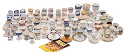 An extensive collection of ceramic egg cups, some 19th/ the majority 20th century,
