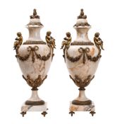 A pair of Continental ochre veined Carrara marble and gilt metal mounted urns in Neoclassical style,