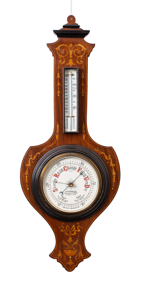 A mahogany shield-shaped aneroid barometer the six-inch dial with usual barometer markings and