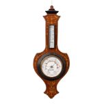 A mahogany shield-shaped aneroid barometer the six-inch dial with usual barometer markings and