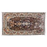 A Kashmir rug, the indigo mihrab with a design of birds amidst flowering stems,