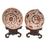 Two Chinese Swatow bowls painted with figures, phoenix, flowers and foliage in iron-red,