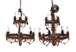 A pair of wrought iron nine light electroliers in Gothic revival taste,