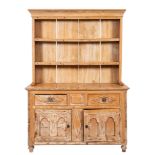 A Cornish pine dresser, the shelved superstructure with a moulded cornice,