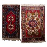 An Afghan Belouch rug, the red pointed field with ivory twin geometric medallions,