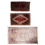 A Kashmir rug, the ivory field with a powder blue flowerhead medallion,