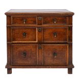 A late 17th Century and later oak chest with three panelled drawers and on stile feet; 82cm high,