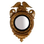 A giltwood framed convex wall mirror in Regency style,