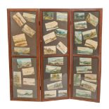 An oak three fold screen with inset watercolour studies of landscapes,
