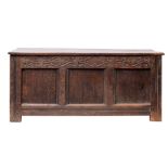 A Carolean oak coffer, circa 1640; with hinged cover,