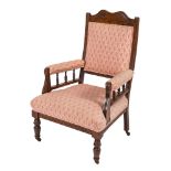 A late Victorian stained upholstered easy chair, with sprung seat,