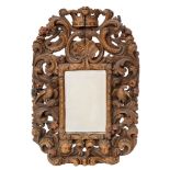 A carved and polychrome oak framed wall mirror in Charles II style,