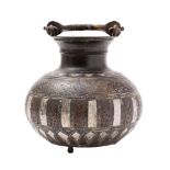A Middle Eastern white-metal and copper inlaid bronze vessel with swing handle,