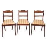 A set of three Regency rosewood sidechairs, circa 1815; the backrests with gadrooned toprails,