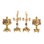 A French gilt metal and enamelled garniture of a pair of three light candelabra and a pair of