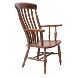 A Victorian oak and elm lath back elbow chair,