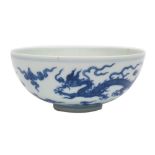 A Chinese blue and white porcelain bowl the exterior painted with a pair of dragons amongst clouds,