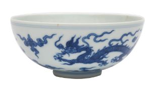 A Chinese blue and white porcelain bowl the exterior painted with a pair of dragons amongst clouds,
