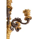 A pair of French patinated and parcel gilt bronze six light candleabra, in Neoclassical style,