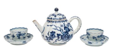 A small Chinese blue and white ribbed teapot and cover and a pair of similar teabowls and saucers,