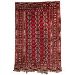 A Turkoman rug, the red field with three rows of quartered guls,