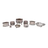 A pair of George V silver napkin rings, Birmingham 1910, a pair of Indian silver napkin rings,