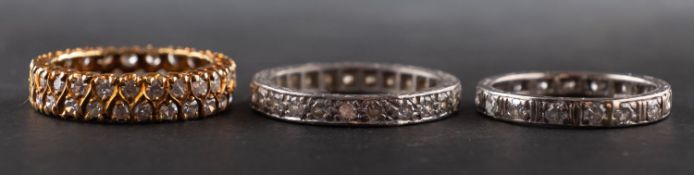 Three single-cut diamond eternity rings, including a double-row ring,