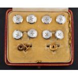 A mother-of-pearl dress stud set including a pair of cufflinks,