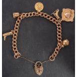 A 9ct gold, curb-link charm bracelet, with heart-shaped clasp,