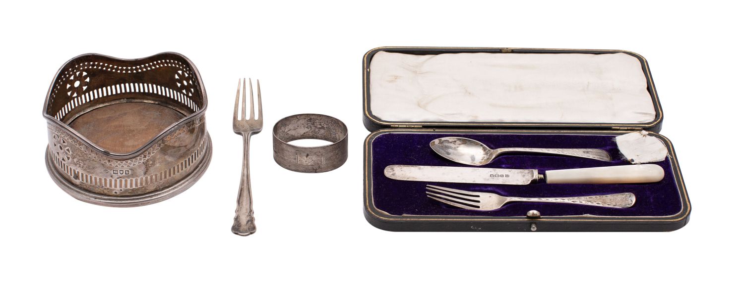 A small group of silver, to include;- a silver bottle coaster, London 1903, a silver dessert fork,