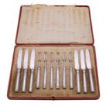 A set of twelve George V silver fruit knives and forks, maker Thomas Bradbury and Son, Sheffield,