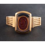 A hemitate and carnelian intaglio ring, depicting the bust of a Greek warrior in profile,