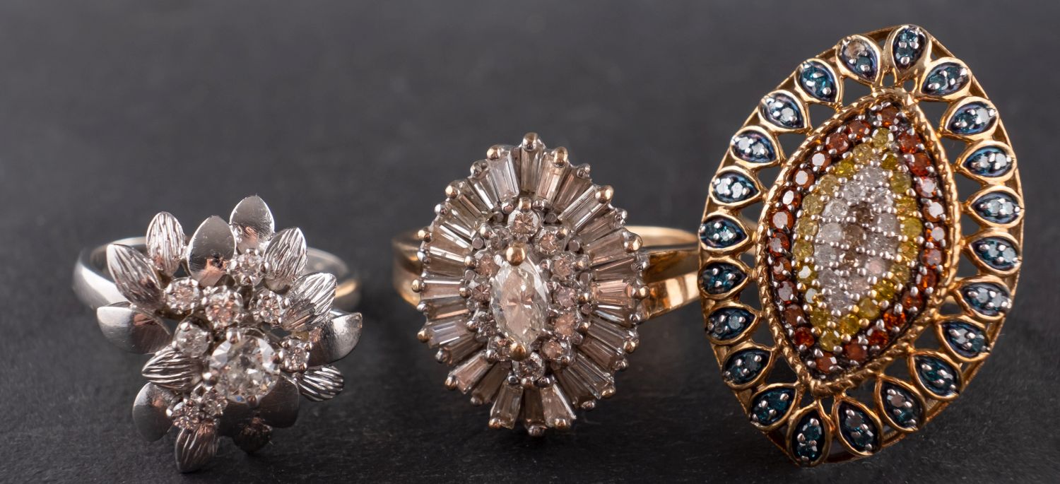 Three diamond rings, including an 18ct gold, flowerhead ring, total estimated diamond weight ca. 0.