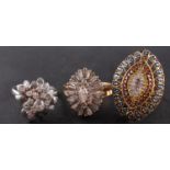 Three diamond rings, including an 18ct gold, flowerhead ring, total estimated diamond weight ca. 0.