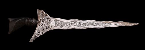 An Indonesian silver paper knife, in the form of a kris with buffolo horn handle,