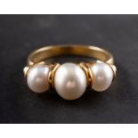 A graduated, cultured pearl, three-stone ring,